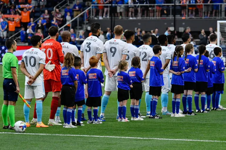 Why Do Soccer Players Walk Out with Children?